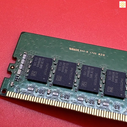 Computer RAM module with visible memory chips and gold-colored connectors.