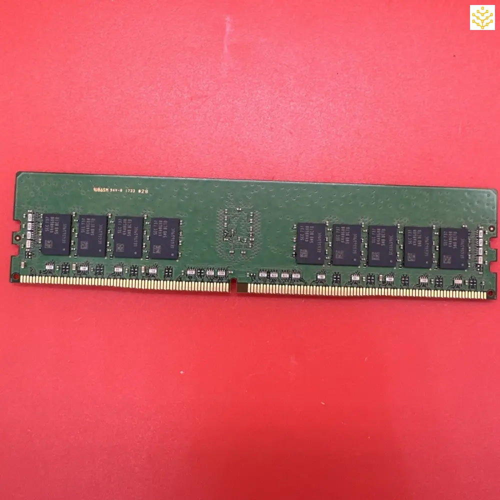 Computer RAM module with black memory chips on a green circuit board.