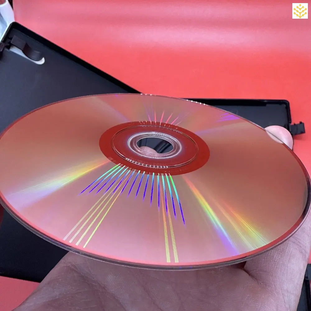 Compact disc (CD) displaying rainbow light reflections across its surface.