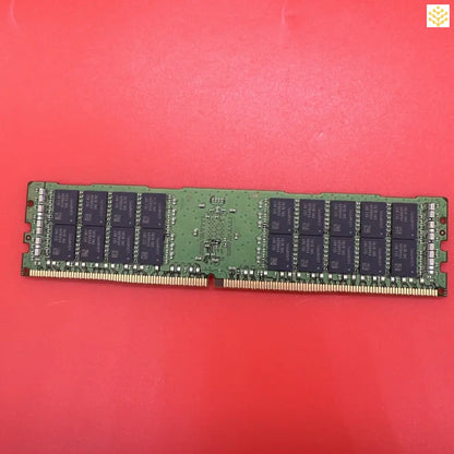 Computer RAM memory stick with black chips mounted on a green circuit board.