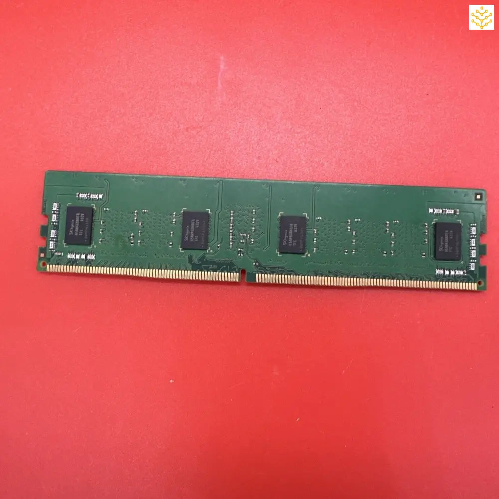 Computer RAM stick with visible integrated circuits on a green circuit board.