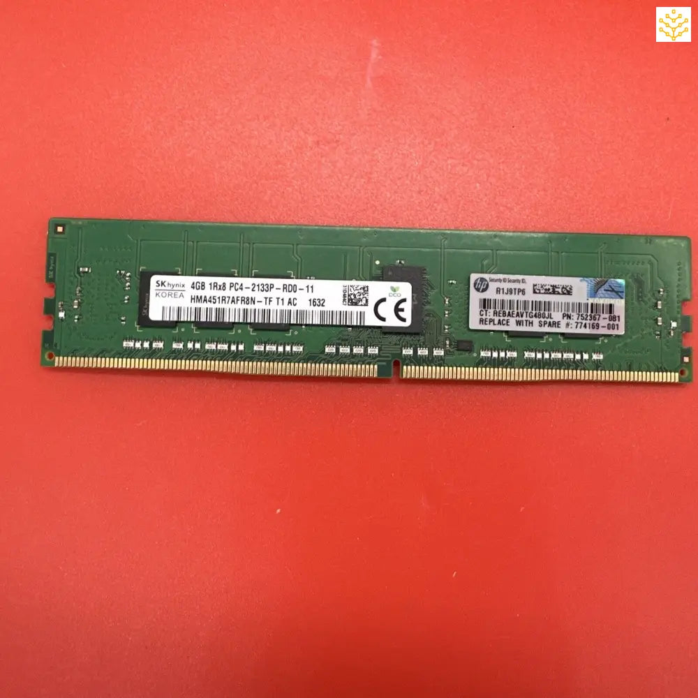 Computer RAM stick with green circuit board and white labels.