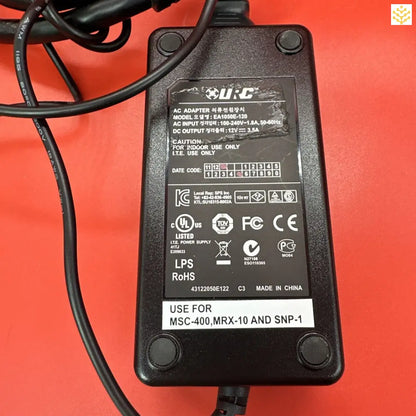 Power adapter or charger with technical specifications printed on its casing.