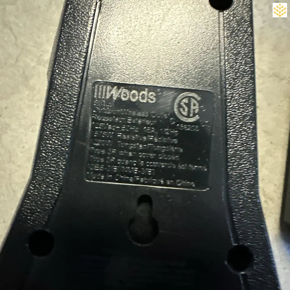 Black plastic component with ’Woods’ branding and SE certification mark.