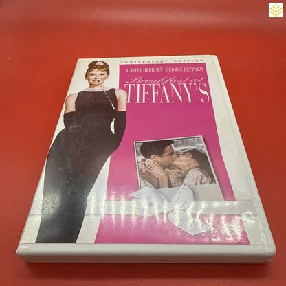 DVD case of the classic film ’Breakfast at Tiffany’s’ featuring a pink and white color scheme.