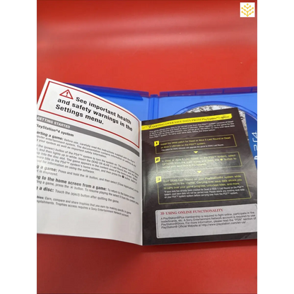 Open instruction manual or safety guide with visible warning text and multiple pages.