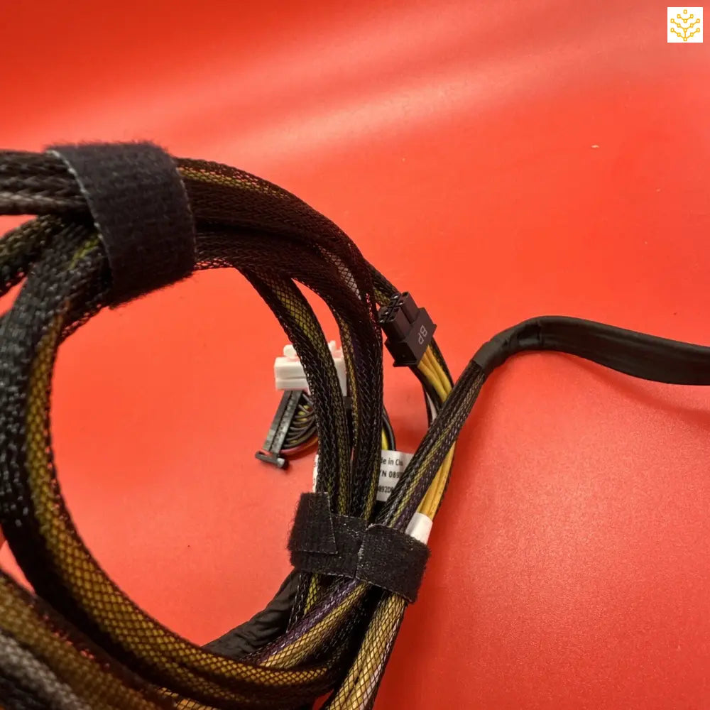 Bundle of electrical or computer cables tied together with black fasteners.