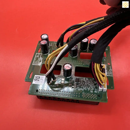 Circuit board with various electronic components and wires attached.