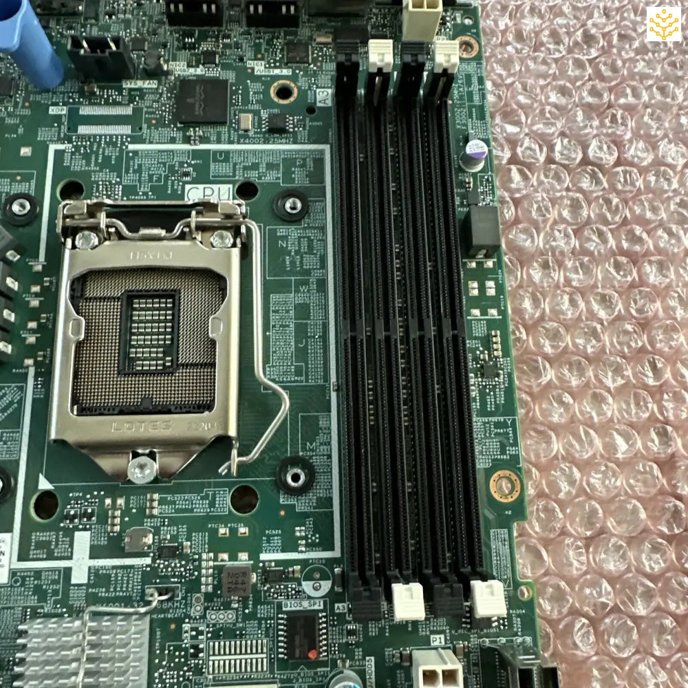 Computer motherboard with visible CPU socket and RAM slots.