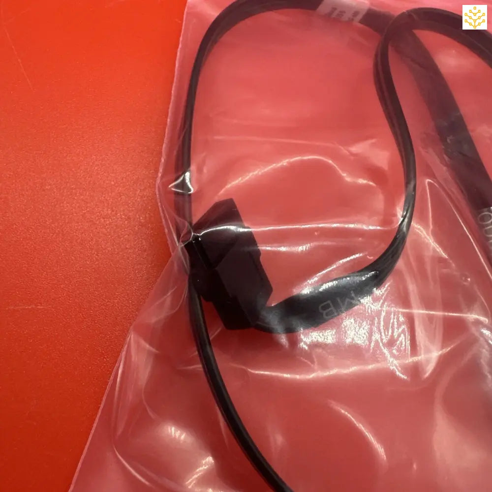 Headset or headphones sealed in a clear plastic bag.