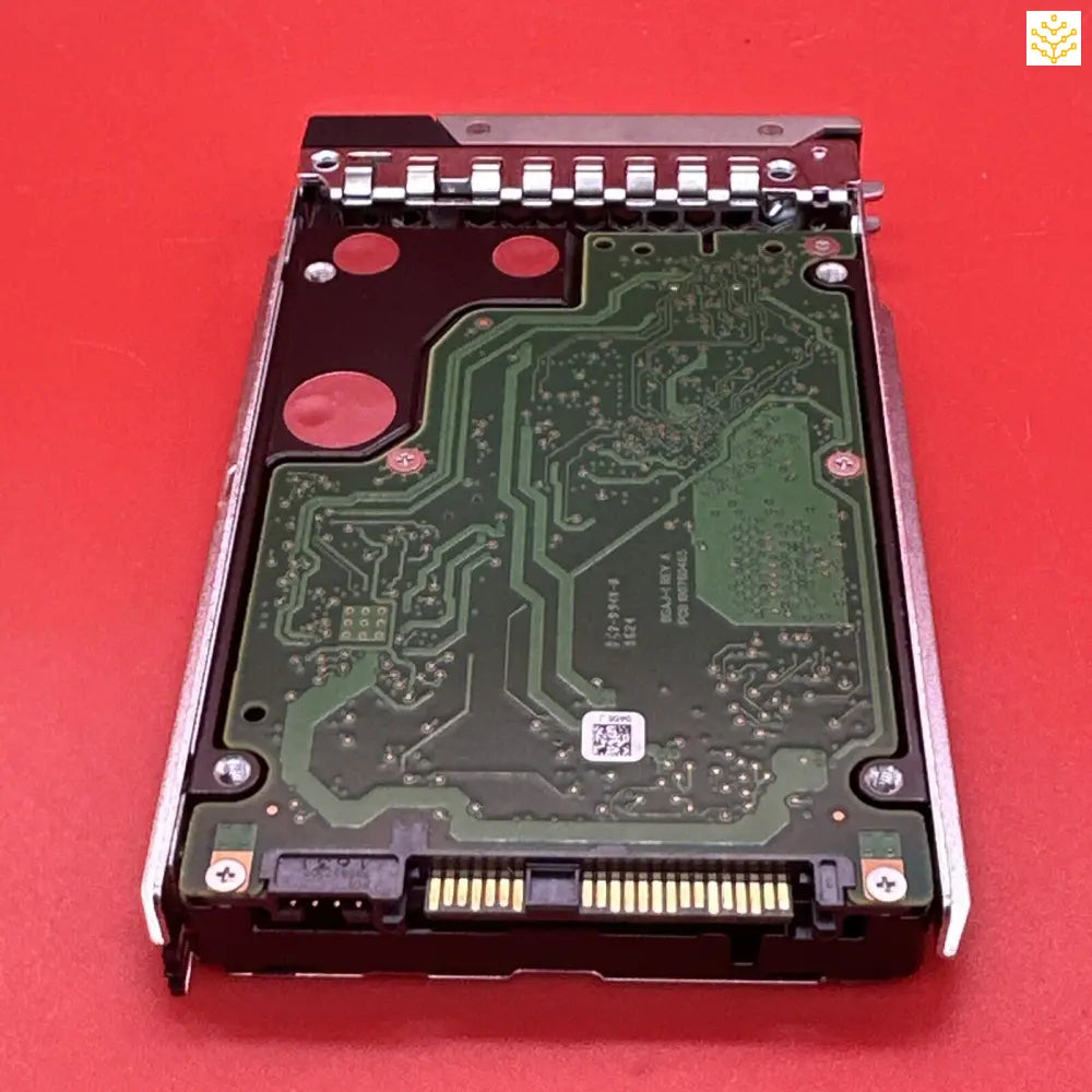 Hard drive or solid-state drive in a metal mounting bracket, showing the circuit board side.