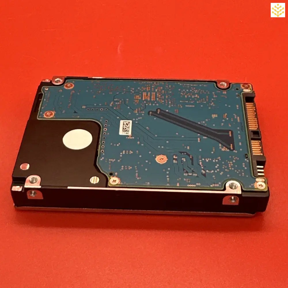 Hard disk drive with its circuit board exposed.