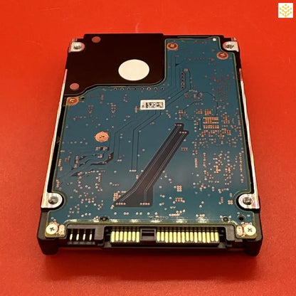 Hard disk drive with its circuit board exposed.