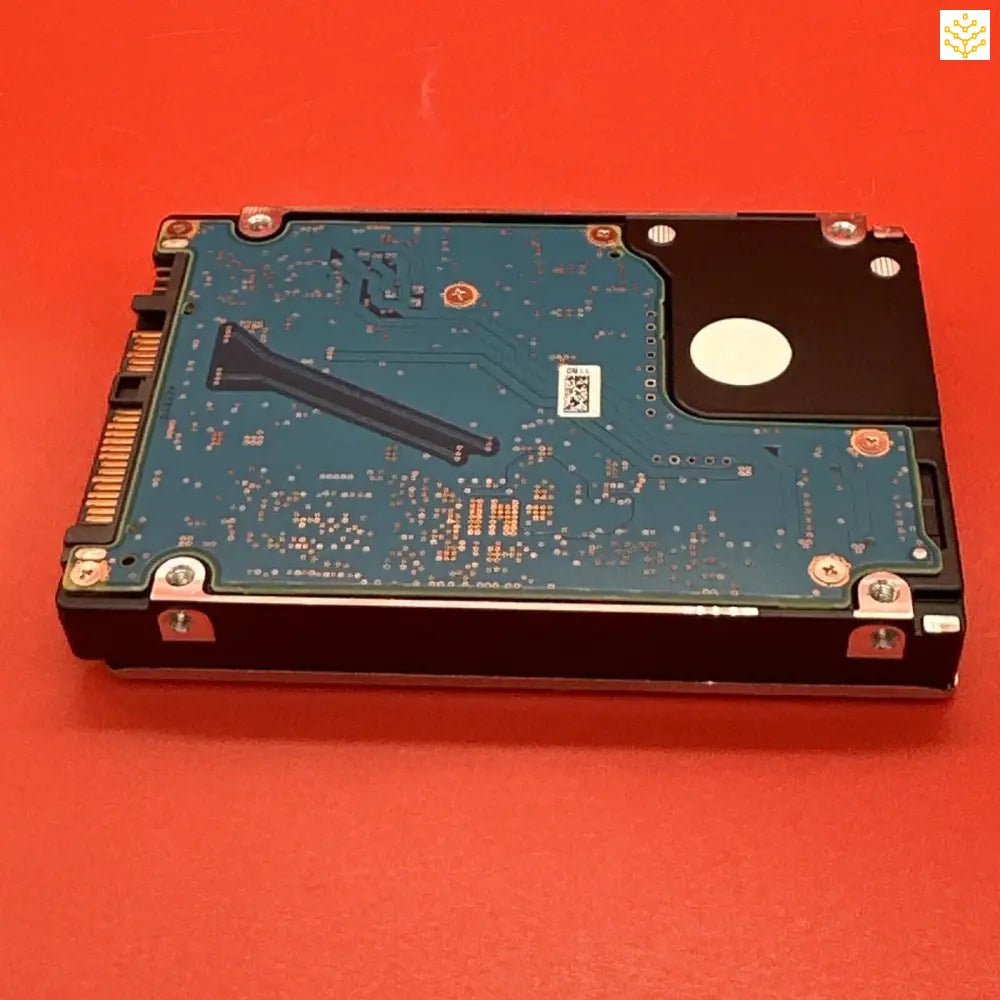 Hard disk drive with its circuit board exposed.