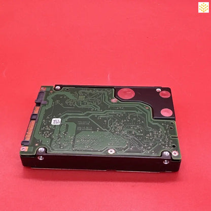 Hard disk drive with its circuit board exposed.