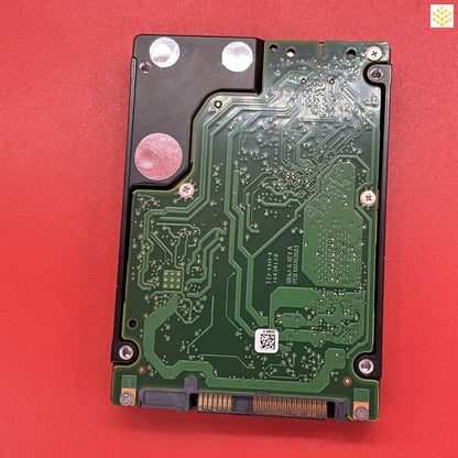 Hard disk drive with its circuit board exposed.