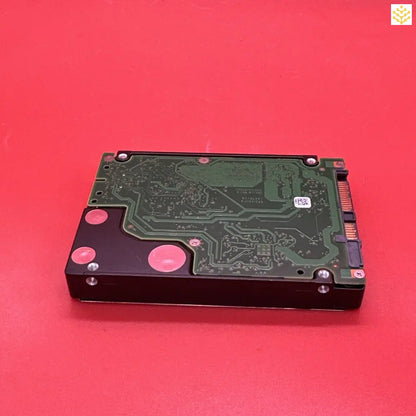 Hard disk drive with its circuit board exposed.