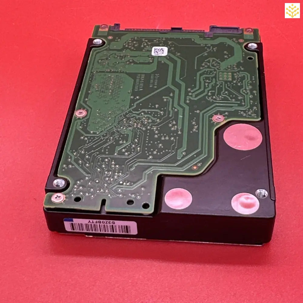 Hard disk drive with its circuit board exposed.