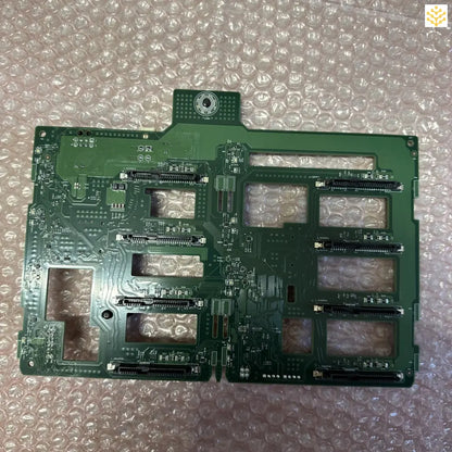 Green circuit board with multiple slots and electronic components.