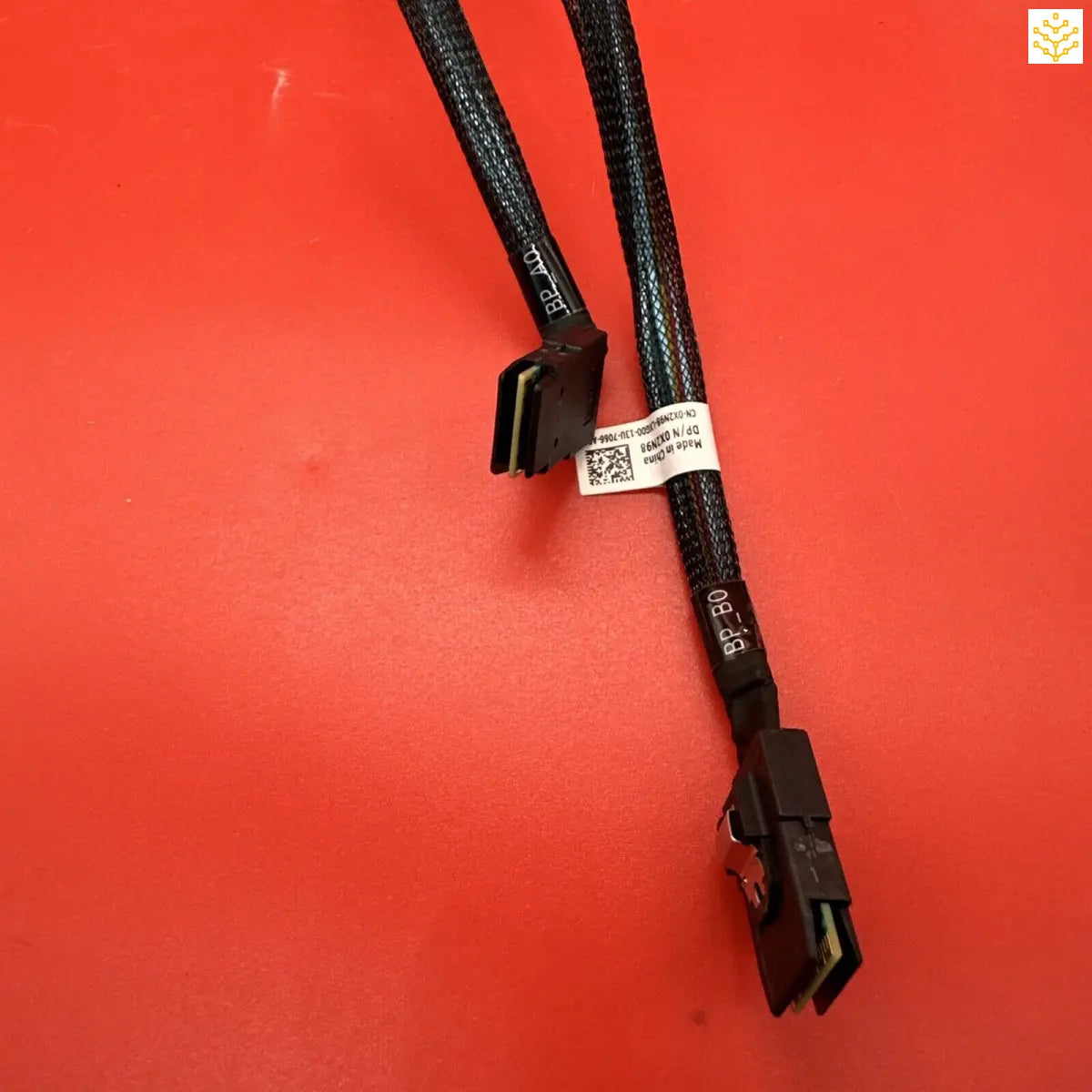 Computer cable with black connectors on a red background.