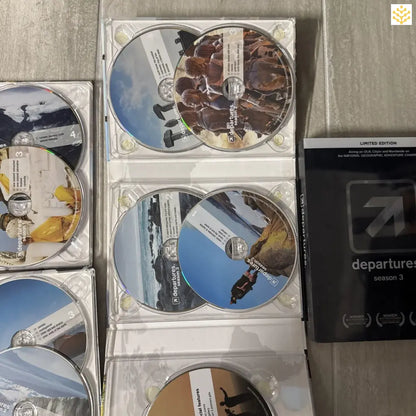 Collection of DVD or Blu-ray discs spread out and partially visible in their cases.