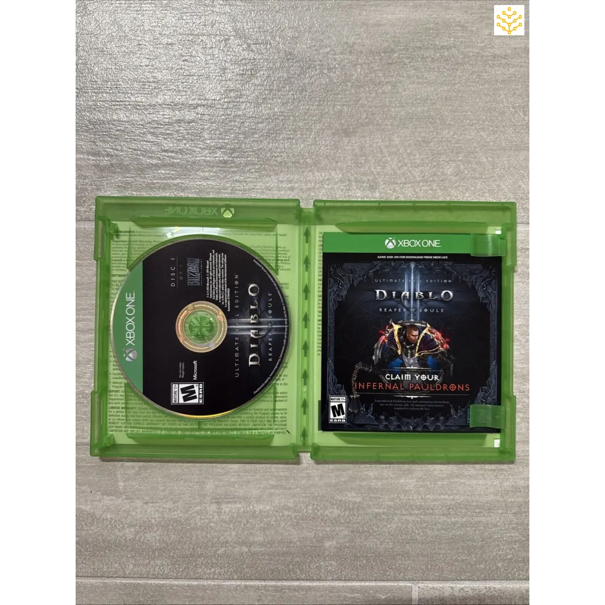 Xbox game case for Diablo II: Resurrected, open to show the disc inside.