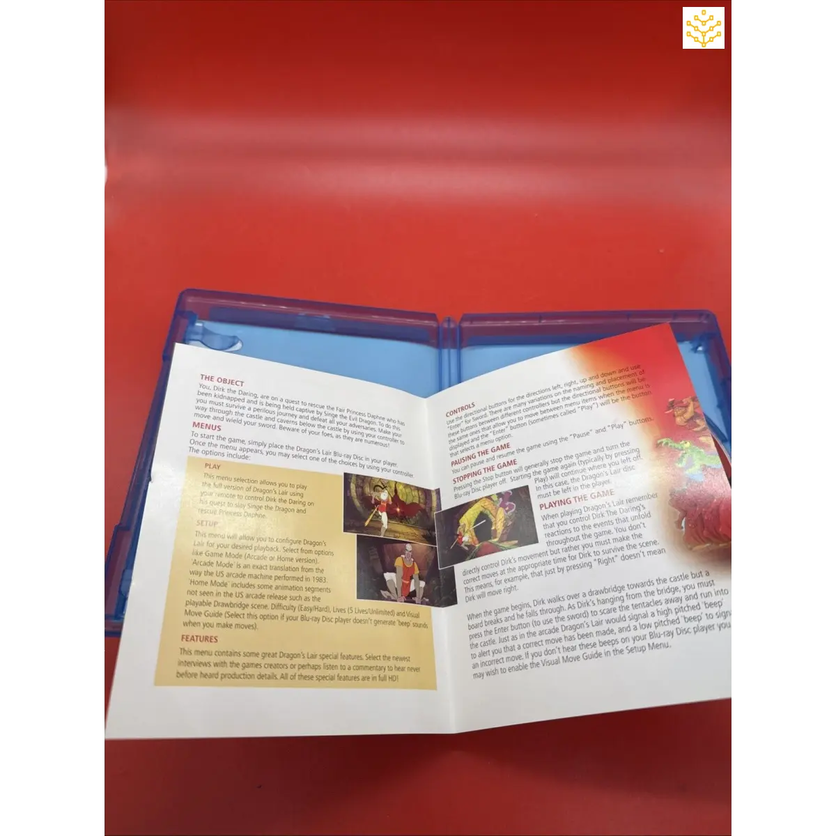 Open book or pamphlet with text and small images visible on its pages.