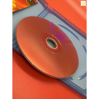 Compact disc (CD) resting on a blue plastic case.