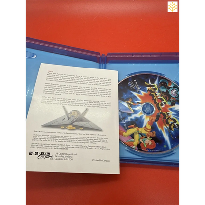 Open Blu-ray case containing a disc and an informational booklet or insert.