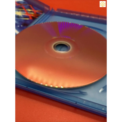 Compact disc (CD) partially inside a blue plastic case.