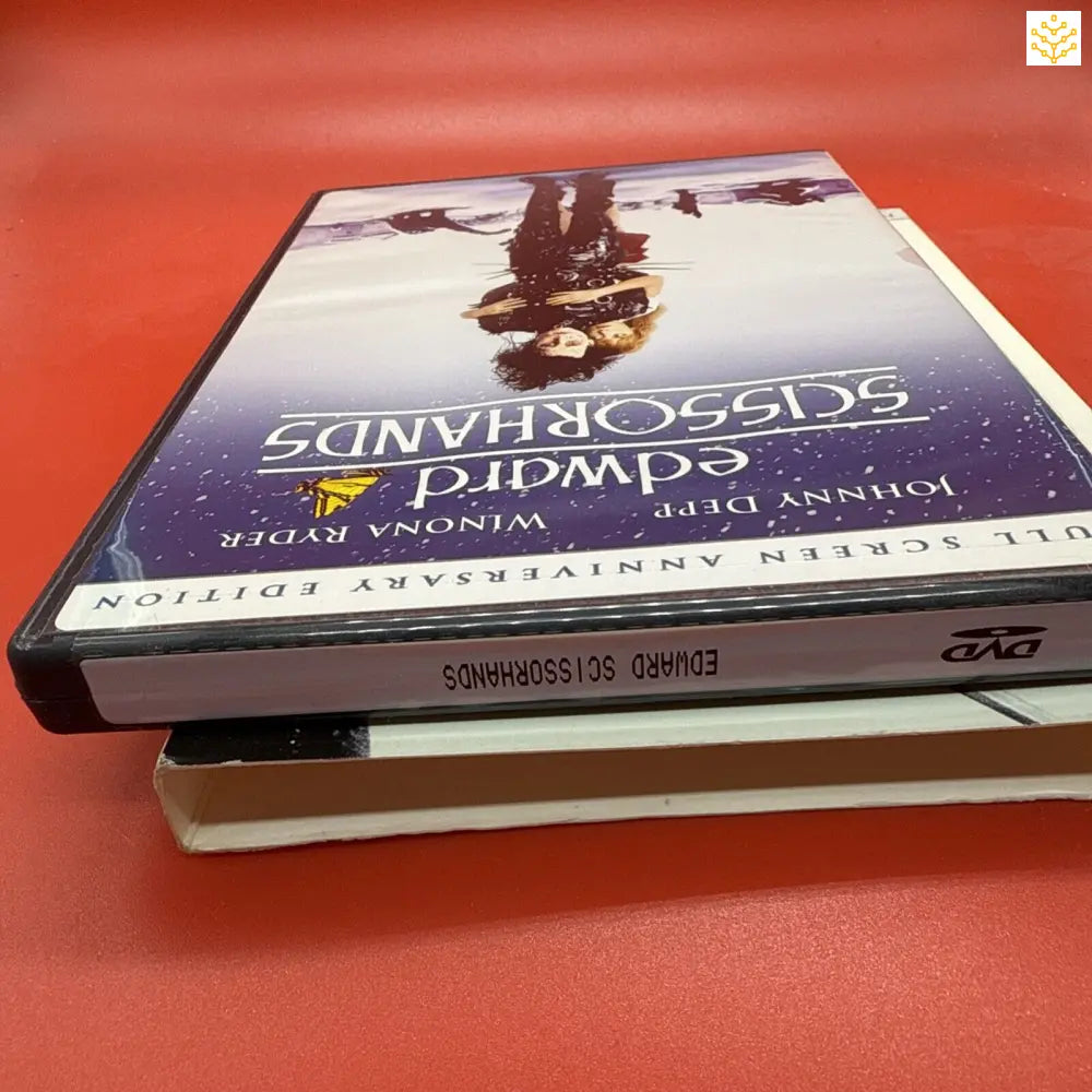 Stack of DVD cases on a surface.