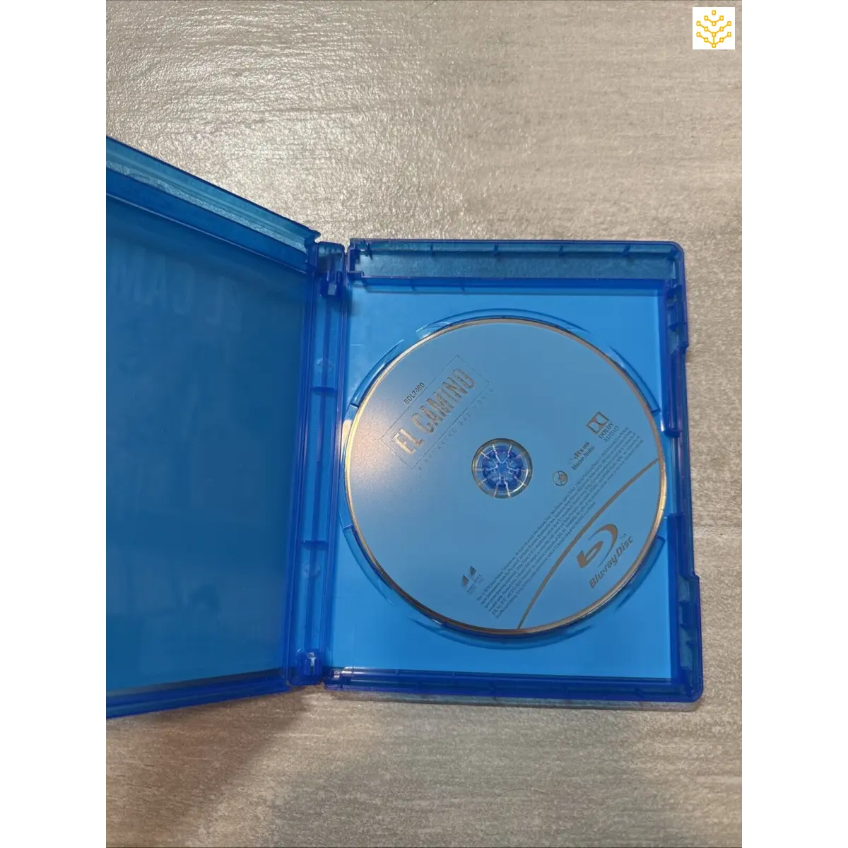 Blu-ray disc inside an opened blue plastic case.