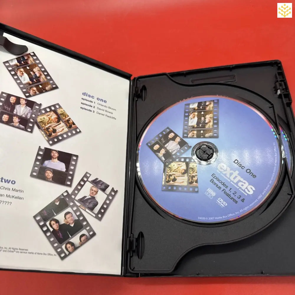 DVD case opened to show a disc and decorative film strip design on the inside cover.