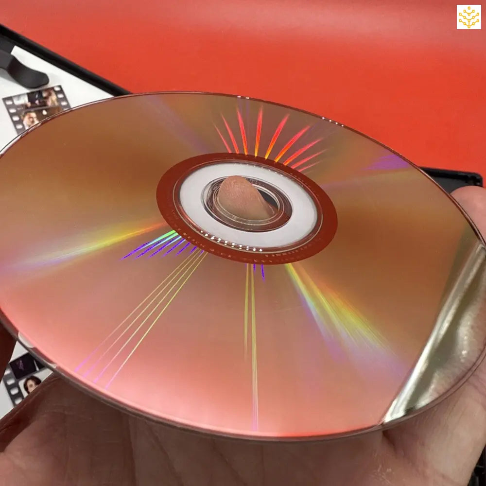 Shiny compact disc (CD) reflecting rainbow colors on its surface.