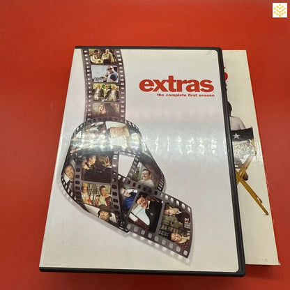 DVD case for the television series ’Extras’ featuring a film strip design on the cover.