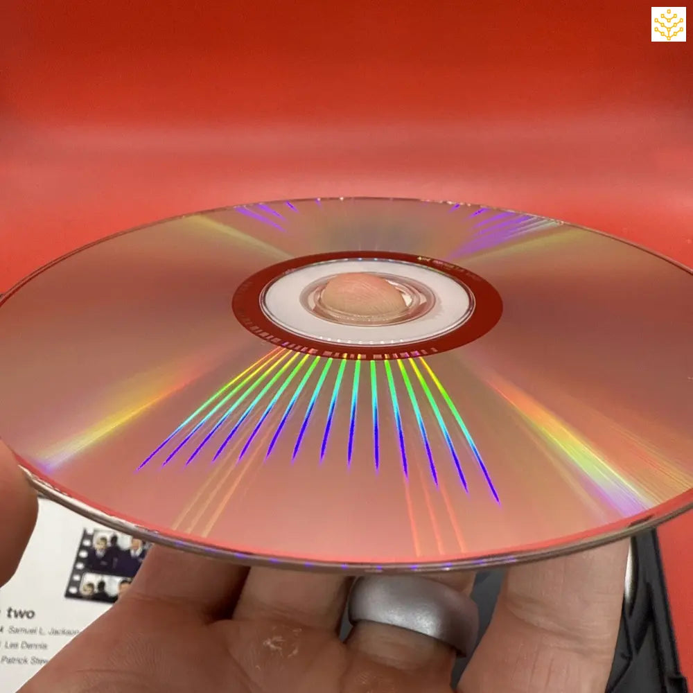 Compact disc (CD) reflecting rainbow-colored light patterns across its metallic surface.