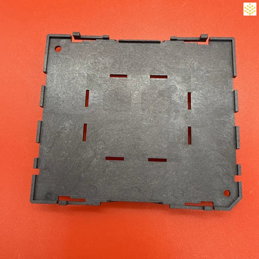 Gray plastic mounting plate with rectangular slots and notched edges.