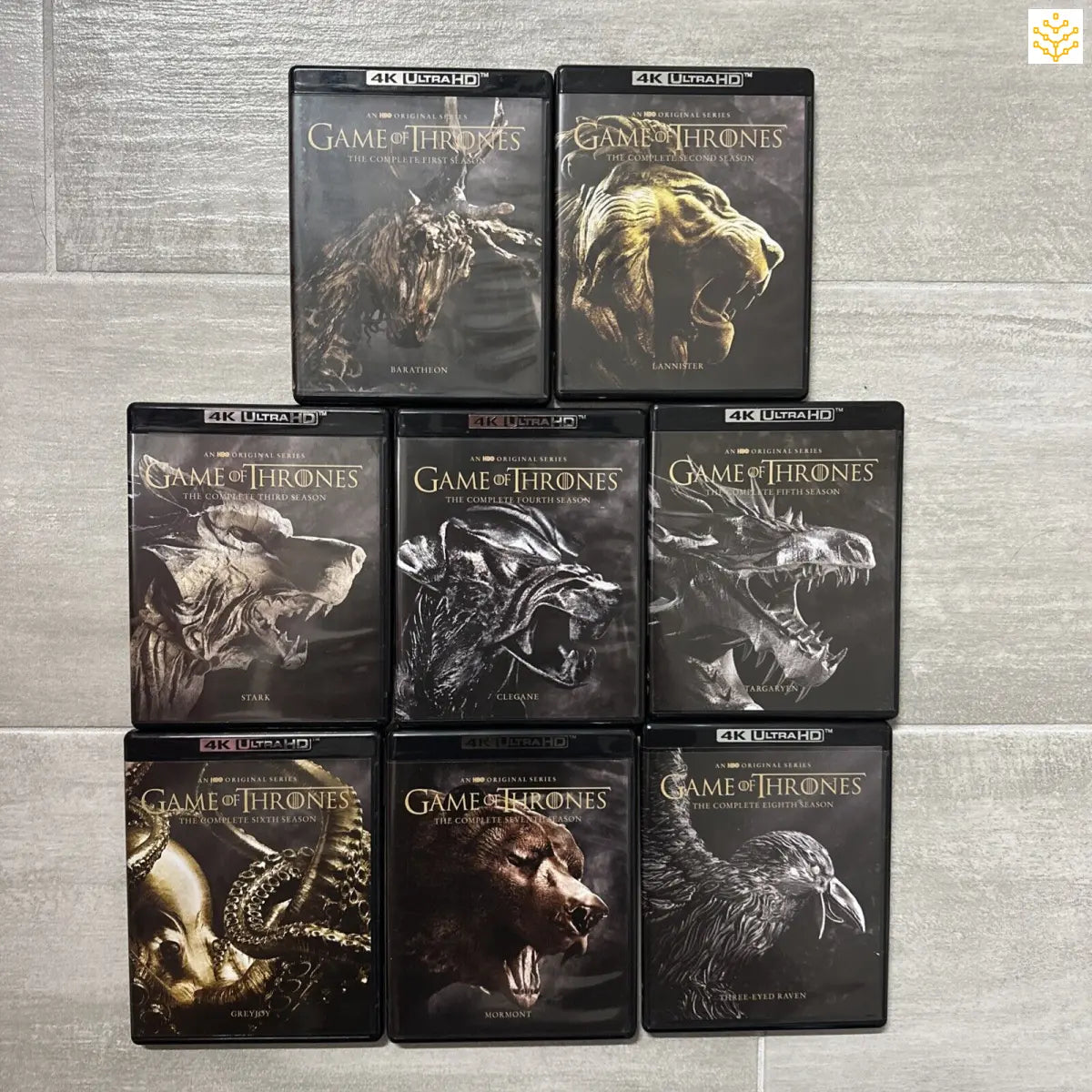 Collection of Game of Thrones 4K Ultra HD Blu-ray season box sets featuring dragon imagery on the covers.