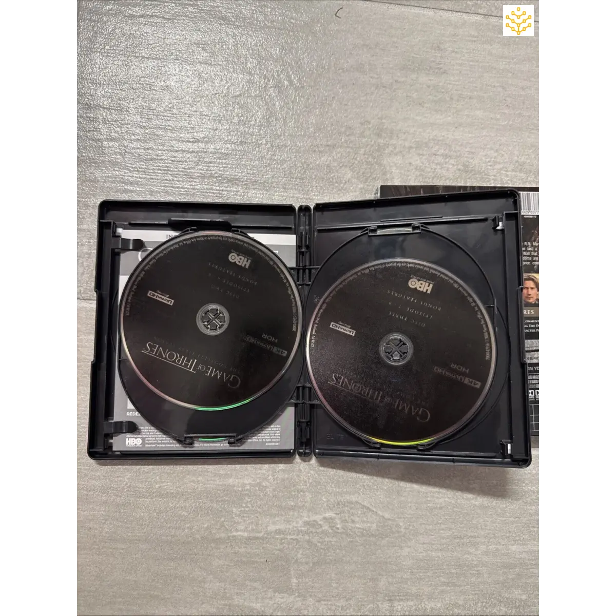 Open DVD case containing two discs.