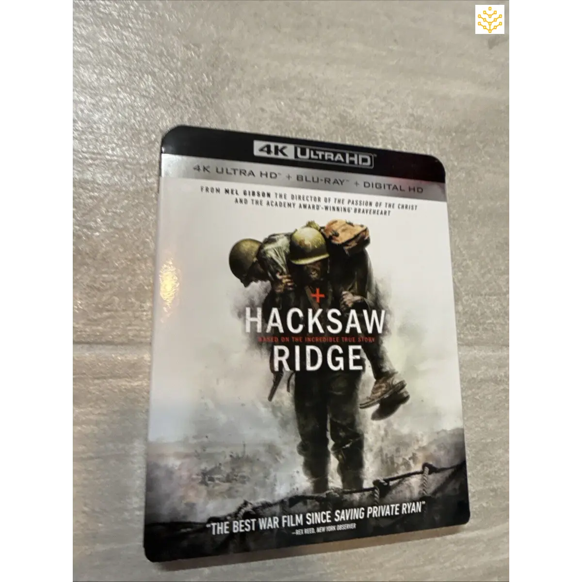 4K Ultra HD Blu-ray case for the movie ’Hacksaw Ridge’ featuring a soldier carrying another on the cover artwork.