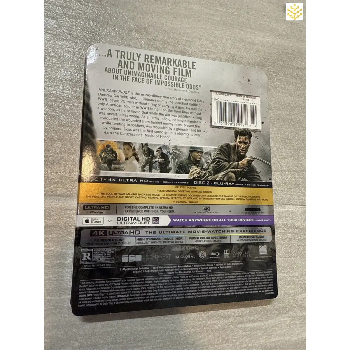 Blu-ray steelbook case for a war movie, likely ’Hacksaw Ridge,’ featuring promotional text and images on the back cover.