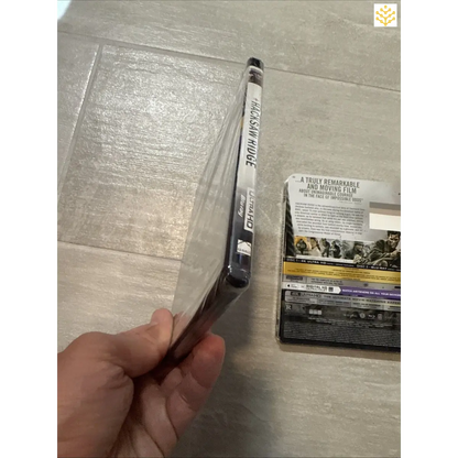 DVD case being held open by a hand.