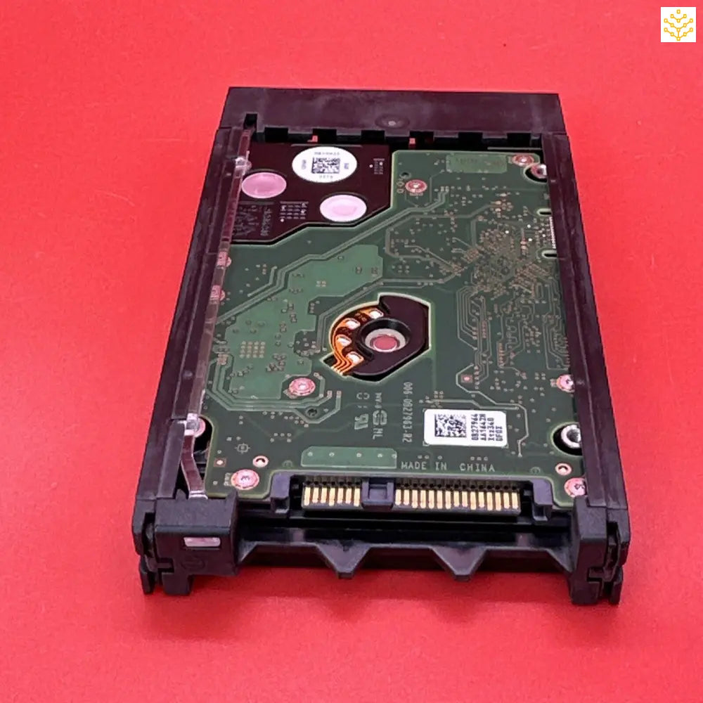 Hard disk drive with its circuit board exposed.