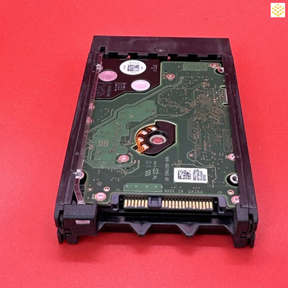 Hard disk drive with its circuit board exposed.