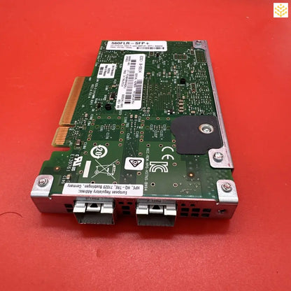 Network interface card with multiple ports and a green circuit board.