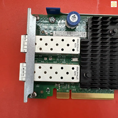 Network interface card with dual SFP ports and a heat sink.