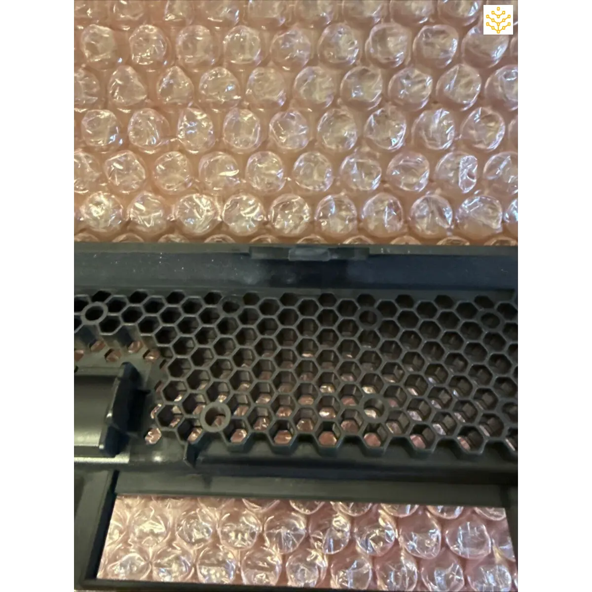 Bubble wrap sits next to a perforated metal grate or mesh panel.