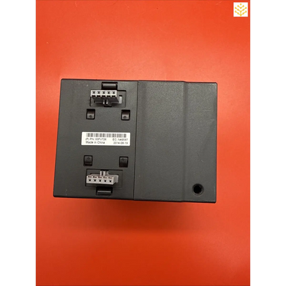 Black electronic control module with connection terminals and a serial number label.