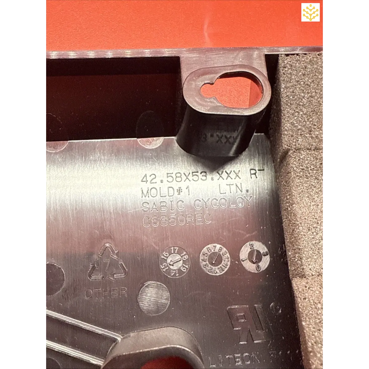 Metal component with stamped serial numbers and certification marks.