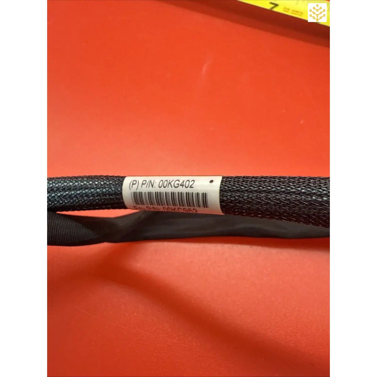 Black braided cable sleeve with a white label attached.